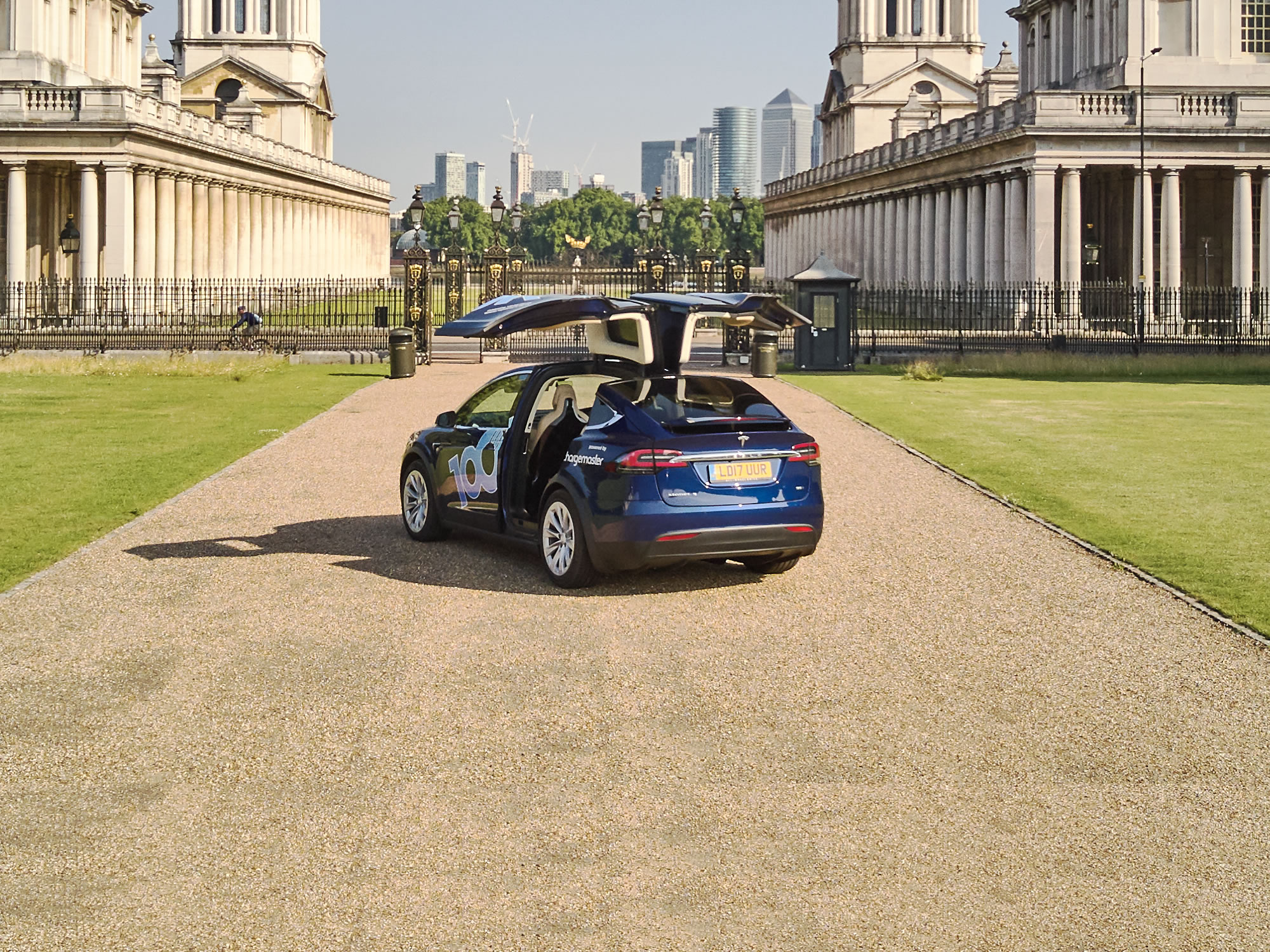 Tesla X type vehicle in the Greenwich area of London overlooking the city financial district
