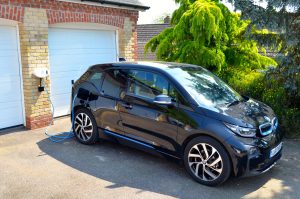BMW i3 charging at a Chargemaster tethered wall mounted home charge unit