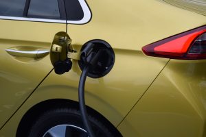 Gold Hyundai IONIQ charging at a Chargemaster EV electric vehicle charging point