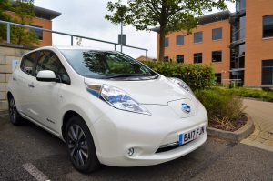 Nissan Leaf charging at a Chargemaster public area wallcharge box in a business park
