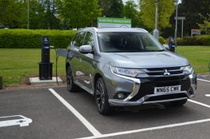 Mitsubishi Outlander PHEV charging at a public electric vehicle bay