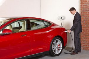 Tesla Model S charging at Chargemaster white tethered homecharge rugby ball shaped unit